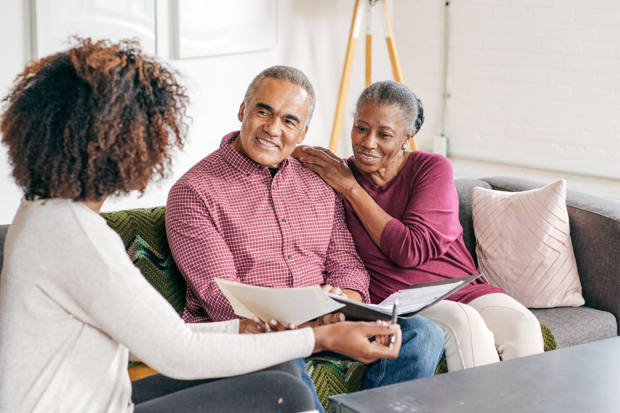 Older couple sitting with another women going over paperwork