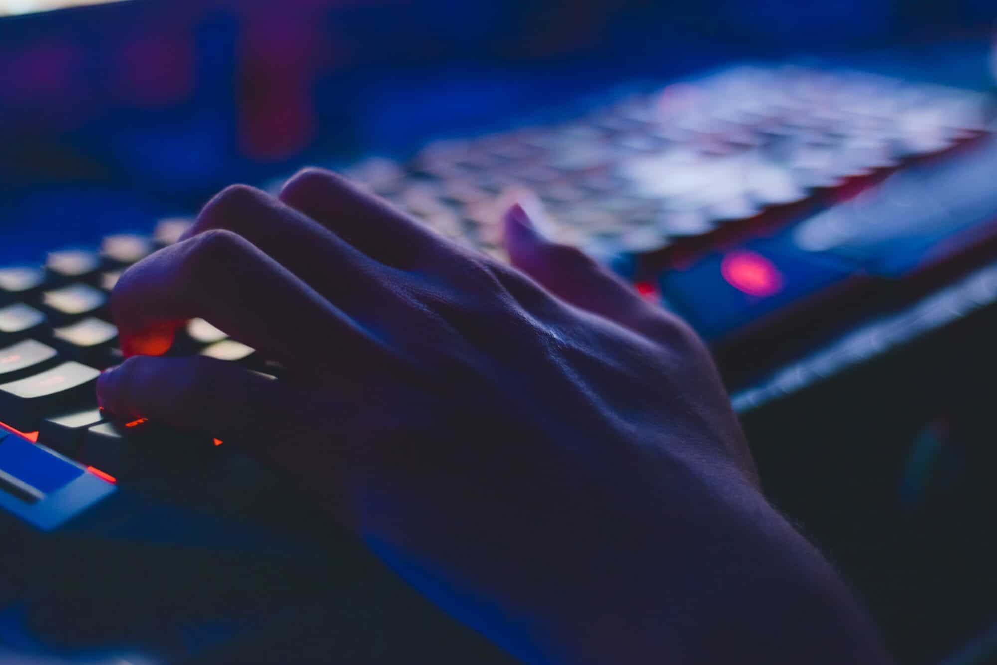 Hands on a neon gaming keyboard