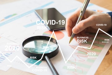 charts with magnify glass relating to COVID-19