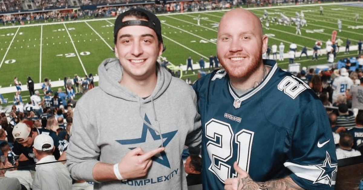 Picture of Cloakzy and Tim the Tatman standing in front of football field