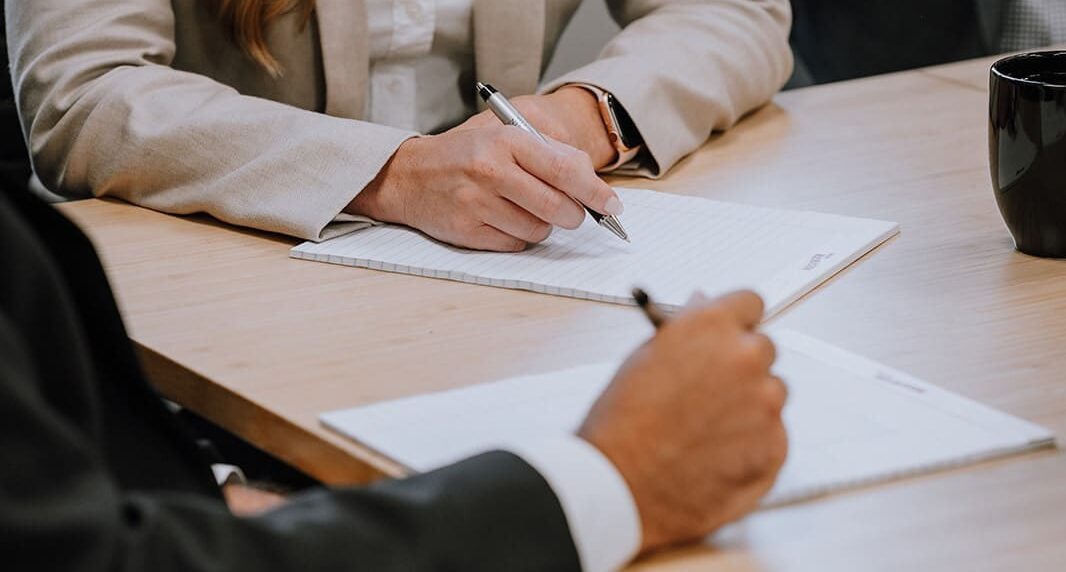 A female attorney writing on a piece of paper